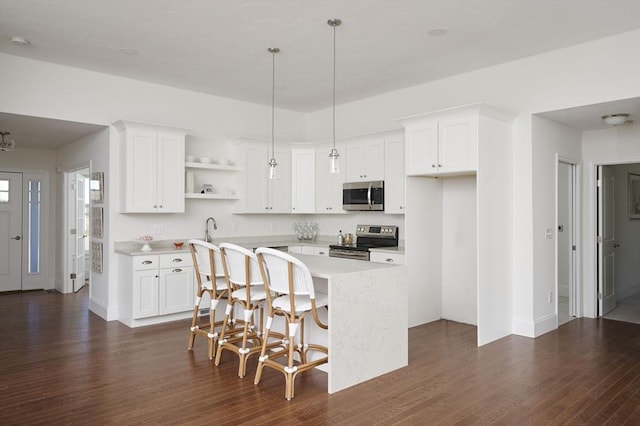 kitchen featuring a center island, white cabinetry, and stainless steel appliances