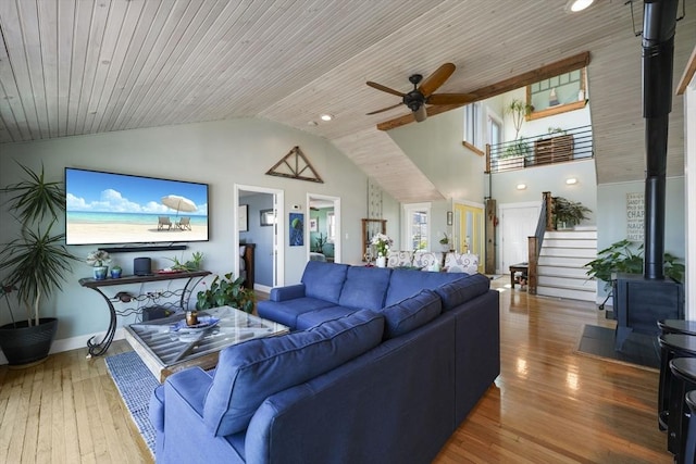 21 Hudson St, New Bedford, MA 02744 - living room featuring a wood stove, stairs, a ceiling fan, wood-type flooring, and baseboards