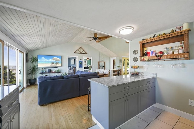 21 Hudson St, New Bedford, MA 02744 - kitchen featuring a peninsula, a ceiling fan, lofted ceiling, gray cabinets, and light stone countertops