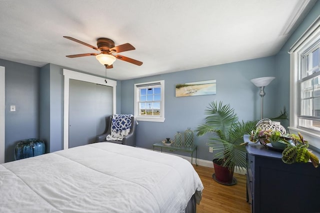 21 Hudson St, New Bedford, MA 02744 - bedroom featuring wood finished floors, a ceiling fan, baseboards, and a closet