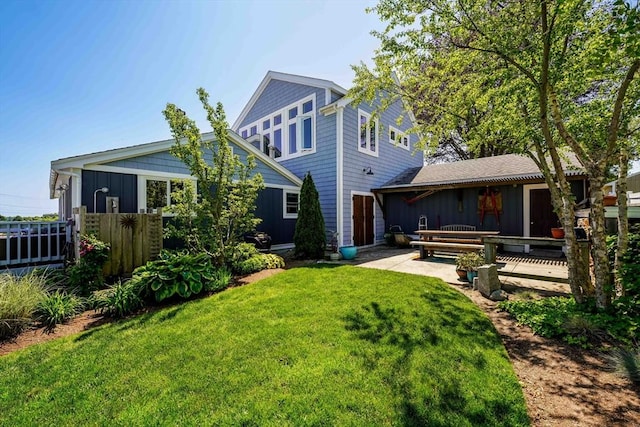 21 Hudson St, New Bedford, MA 02744 - rear view of house with board and batten siding and a patio