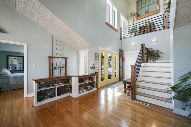 21 Hudson St, New Bedford, MA 02744 - entryway featuring french doors, hardwood / wood-style flooring, stairway, a towering ceiling, and baseboards