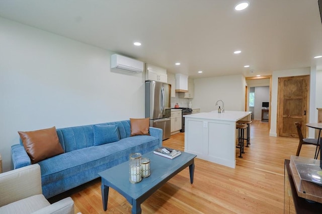 307 E Eagle St, Boston, MA 02128 - living area with a wall unit AC, light wood-type flooring, and recessed lighting