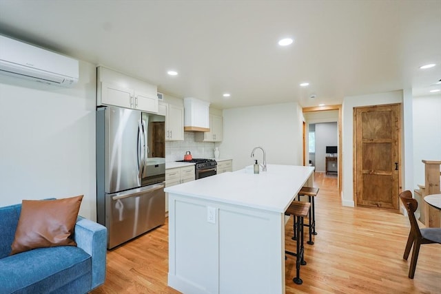 307 E Eagle St, Boston, MA 02128 - kitchen with smart refrigerator, a wall mounted air conditioner, range with gas stovetop, light wood-type flooring, and a kitchen bar