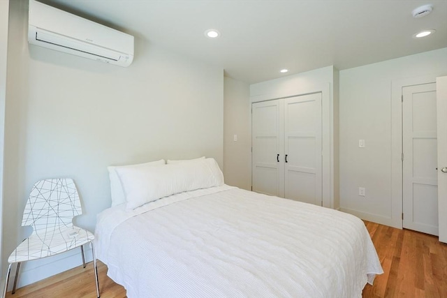 307 E Eagle St, Boston, MA 02128 - bedroom with a wall mounted air conditioner, wood finished floors, a closet, and recessed lighting