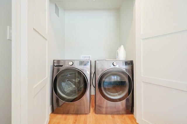 307 E Eagle St, Boston, MA 02128 - laundry area with washer and dryer and wood finished floors