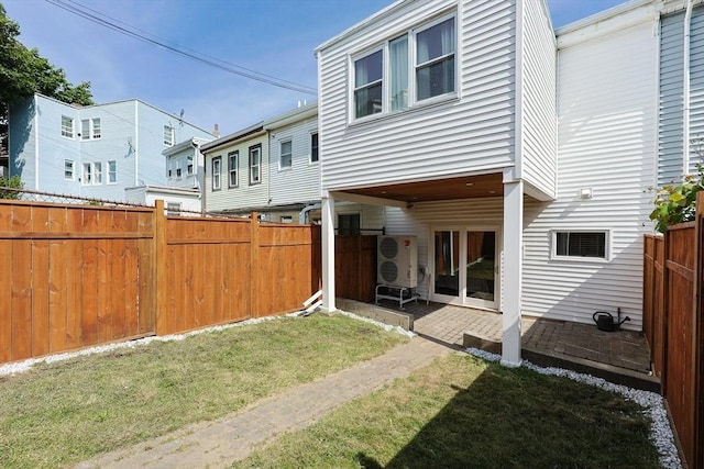 307 E Eagle St, Boston, MA 02128 - rear view of house with a fenced backyard and a patio