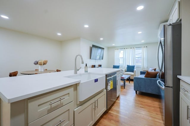 307 E Eagle St, Boston, MA 02128 - kitchen with appliances with stainless steel finishes, light wood-type flooring, open floor plan, light countertops, and recessed lighting