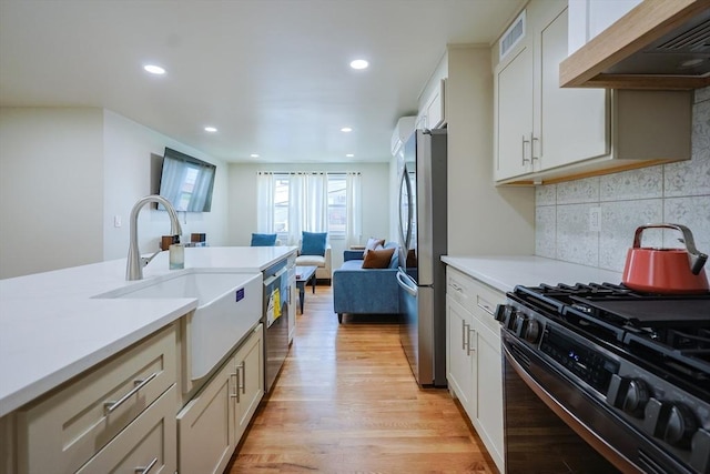 307 E Eagle St, Boston, MA 02128 - kitchen with appliances with stainless steel finishes, extractor fan, light wood finished floors, light countertops, and recessed lighting