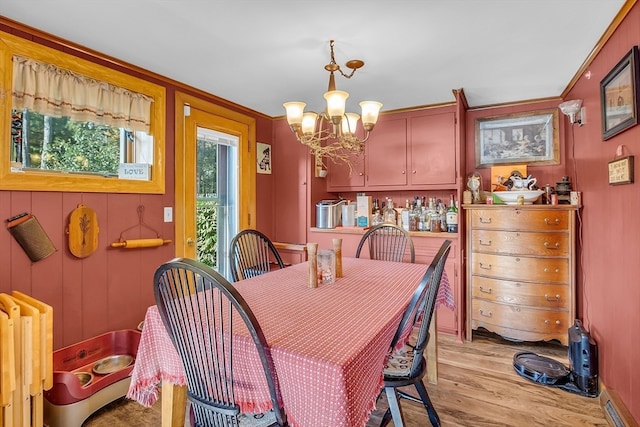 dining area with radiator, a notable chandelier, and light hardwood / wood-style flooring