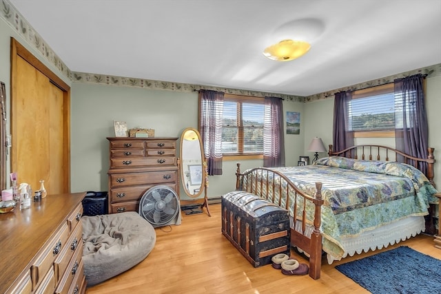 bedroom with light wood-type flooring and a closet