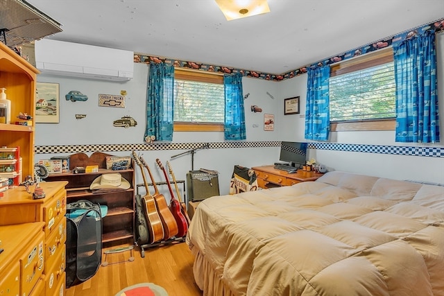 bedroom featuring light hardwood / wood-style flooring, multiple windows, and an AC wall unit