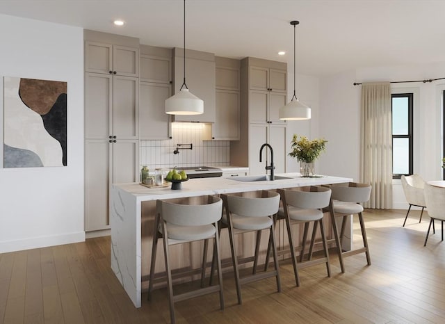 33 Pearl St Unit 6, Boston, MA 02125 - kitchen with a sink, recessed lighting, backsplash, light wood-style flooring, and light countertops