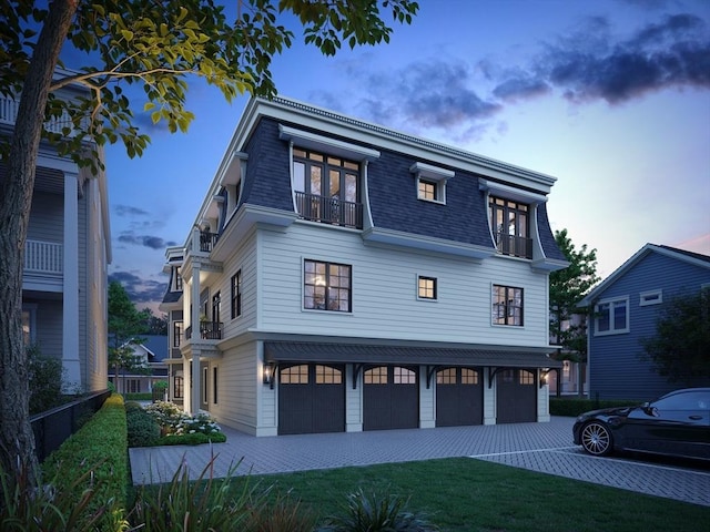 33 Pearl St Unit 6, Boston, MA 02125 - view of front of home with a balcony, mansard roof, a garage, a shingled roof, and driveway