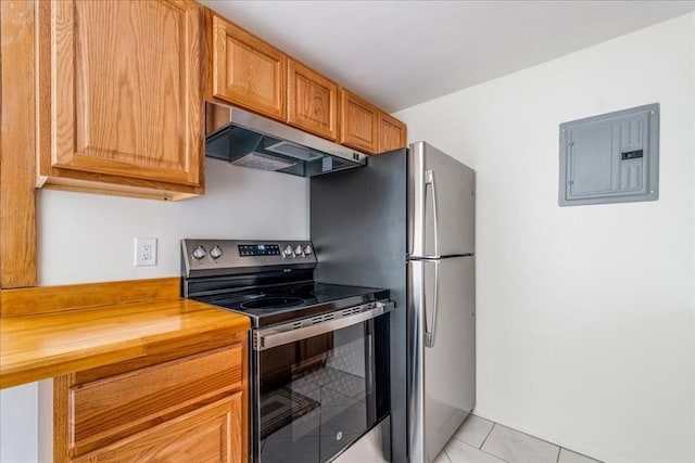 kitchen with electric panel, light tile patterned flooring, under cabinet range hood, wooden counters, and appliances with stainless steel finishes