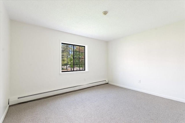spare room featuring carpet, baseboards, and baseboard heating