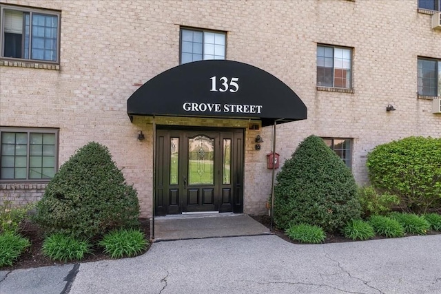 property entrance with brick siding