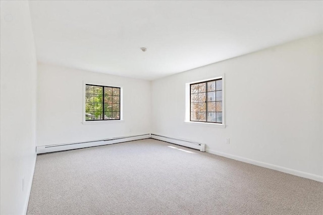 carpeted empty room featuring baseboards