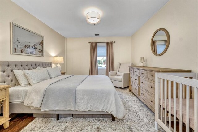 bedroom with hardwood / wood-style flooring