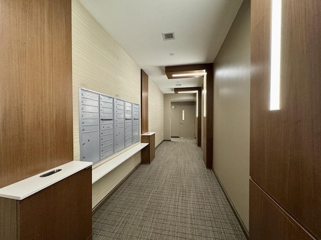 hall with mail area and carpet