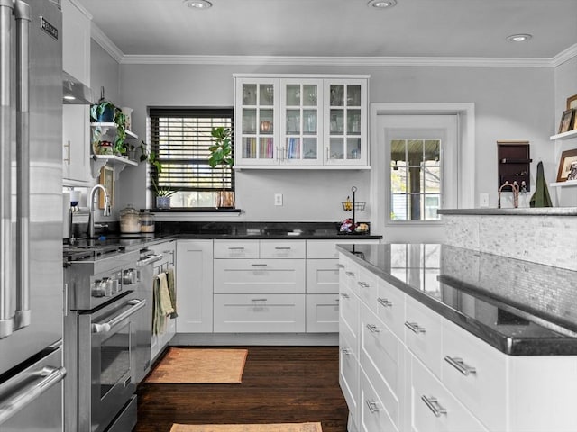 kitchen featuring appliances with stainless steel finishes, crown molding, white cabinetry, plenty of natural light, and recessed lighting