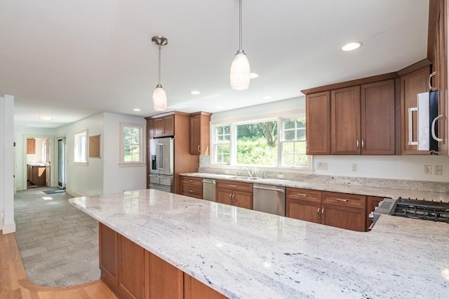 26 N Hillside Rd, Deerfield, MA 01373 - kitchen featuring stainless steel appliances, light stone countertops, pendant lighting, recessed lighting, and brown cabinetry