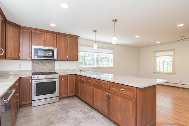 26 N Hillside Rd, Deerfield, MA 01373 - kitchen with appliances with stainless steel finishes, a peninsula, brown cabinetry, recessed lighting, and light stone counters