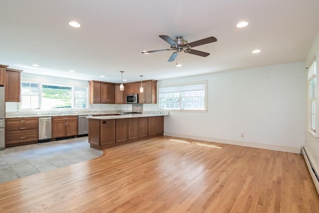 26 N Hillside Rd, Deerfield, MA 01373 - kitchen with stainless steel appliances, recessed lighting, light countertops, a peninsula, and brown cabinetry