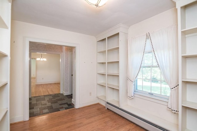 26 N Hillside Rd, Deerfield, MA 01373 - empty room with baseboard heating, a chandelier, and wood finished floors