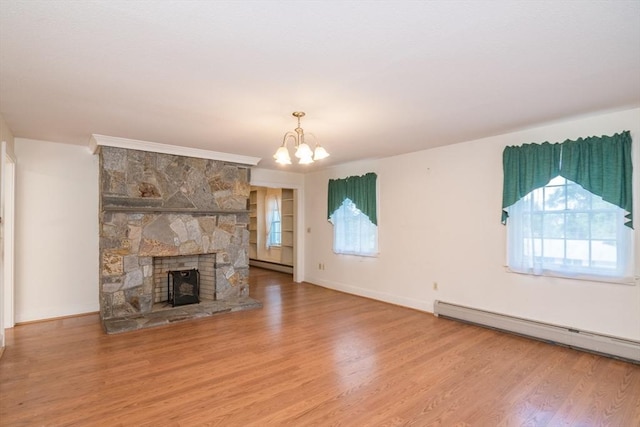 26 N Hillside Rd, Deerfield, MA 01373 - unfurnished living room featuring baseboard heating, wood finished floors, a chandelier, and a fireplace