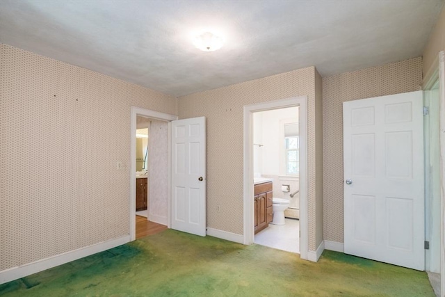 26 N Hillside Rd, Deerfield, MA 01373 - unfurnished bedroom featuring light colored carpet, connected bathroom, and wallpapered walls