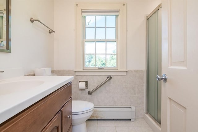 26 N Hillside Rd, Deerfield, MA 01373 - bathroom featuring a baseboard heating unit, tile patterned floors, vanity, healthy amount of natural light, and tile walls