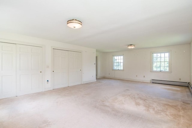 26 N Hillside Rd, Deerfield, MA 01373 - unfurnished bedroom with two closets, baseboard heating, and light colored carpet