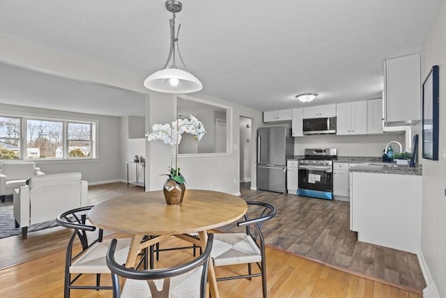 dining room featuring baseboards and wood finished floors