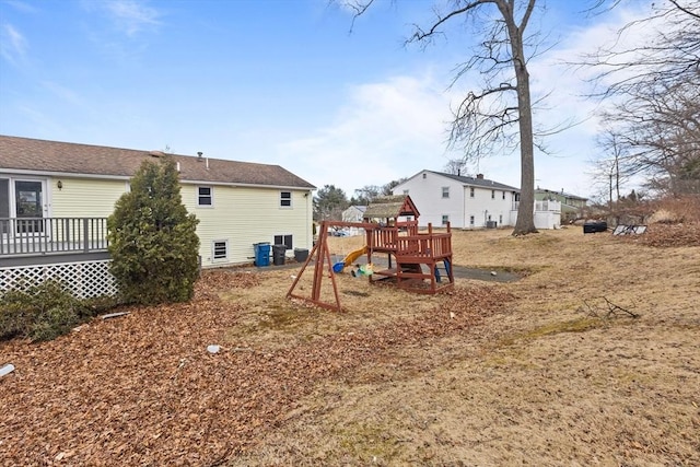 back of property featuring a playground