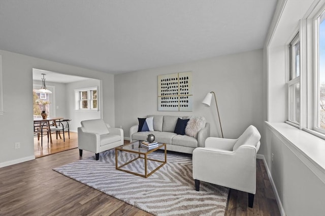 living area with wood finished floors and baseboards