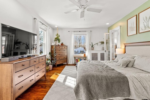 bedroom with a ceiling fan and dark wood-style flooring