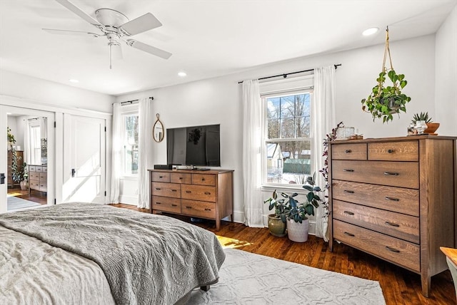 bedroom with baseboards, dark wood finished floors, a ceiling fan, and recessed lighting