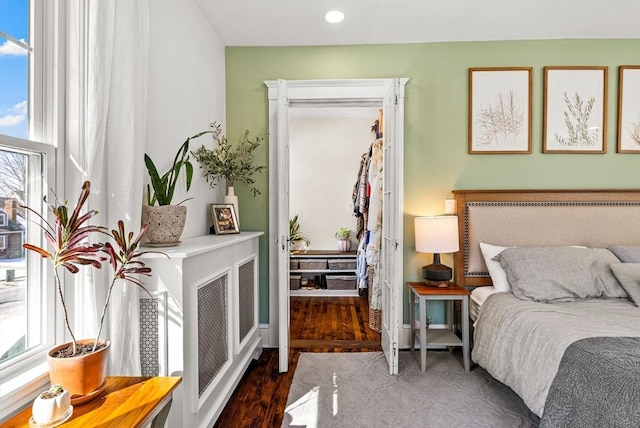 bedroom featuring baseboards, visible vents, wood finished floors, and recessed lighting