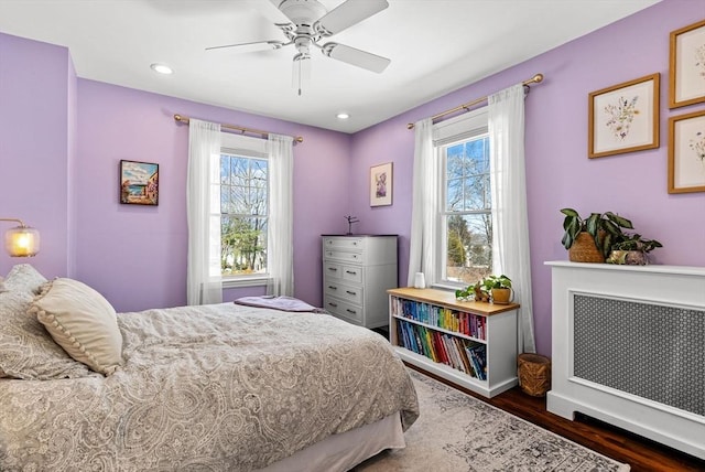 bedroom featuring a ceiling fan, recessed lighting, baseboards, and wood finished floors