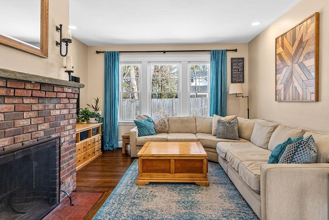 living room featuring dark wood-style floors, a fireplace, and recessed lighting