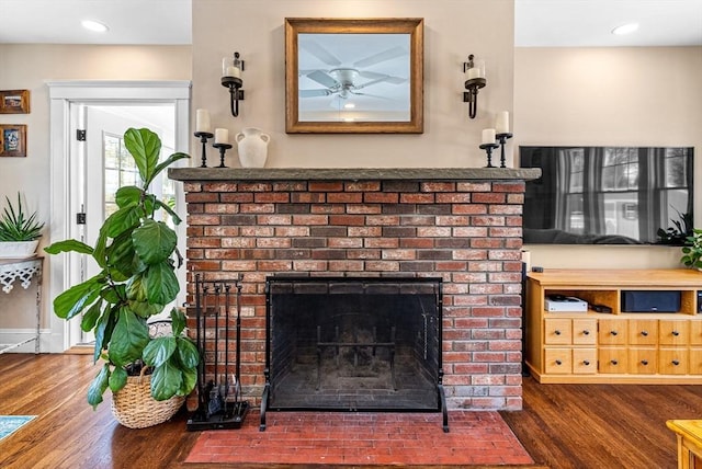 details featuring recessed lighting, a brick fireplace, and wood finished floors