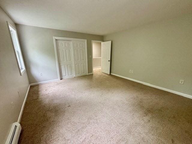 139 E County Rd Unit 139, Rutland, MA 01543 - unfurnished bedroom with baseboard heating, a closet, baseboards, and carpet floors