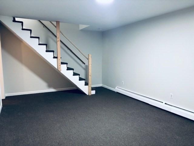 139 E County Rd Unit 139, Rutland, MA 01543 - finished below grade area featuring a baseboard radiator, carpet flooring, stairway, and baseboards