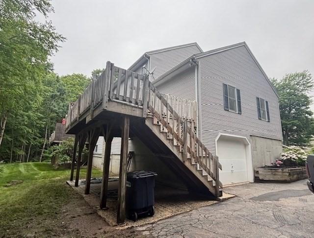 139 E County Rd Unit 139, Rutland, MA 01543 - view of property exterior featuring an attached garage, a yard, asphalt driveway, and stairs