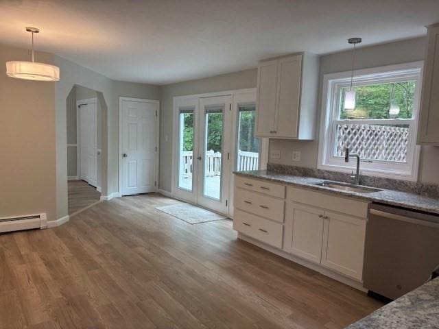 139 E County Rd Unit 139, Rutland, MA 01543 - kitchen with stainless steel dishwasher, a sink, light wood-type flooring, and decorative light fixtures
