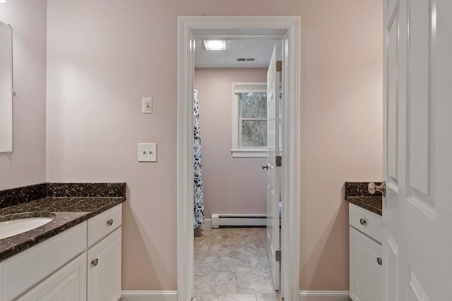 bathroom with visible vents, a baseboard radiator, vanity, and baseboards