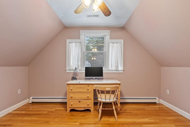 office space with a baseboard heating unit, light wood finished floors, visible vents, and baseboards