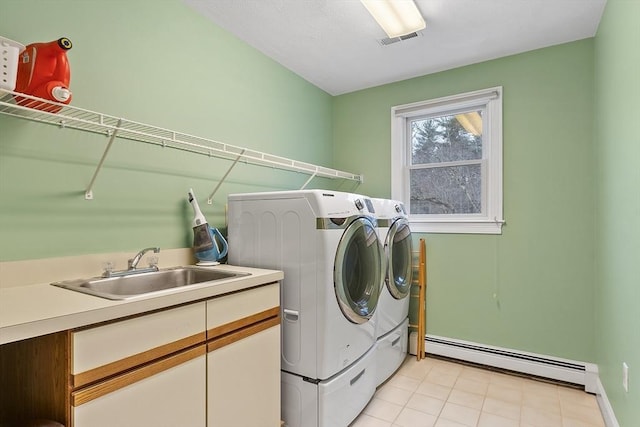 washroom with laundry area, a sink, visible vents, baseboard heating, and independent washer and dryer