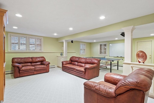 living area featuring ornate columns, carpet, a baseboard heating unit, and recessed lighting